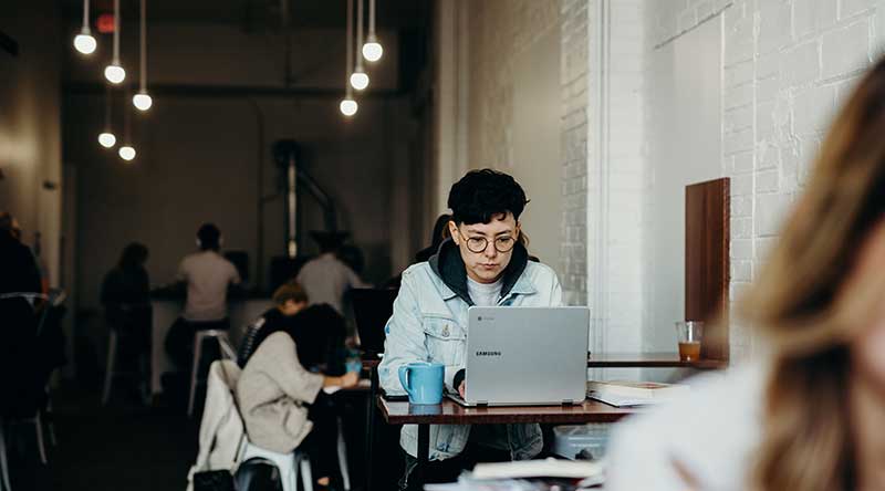 Lady in a cafe using her laptop